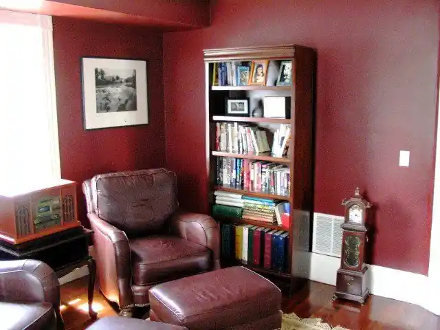 A library painted in a deep red by Renaissance Revival